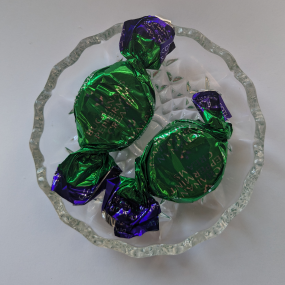 Wrapped chocolate peppermint cream sweets on glass dish